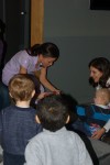 A female Wesbrook Village Dentist show kids how to brush properly